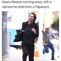 Keanu Reeves running away with a camera he stole froma Paparazzi