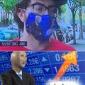 Guy doing an interview on TV with stonks mask