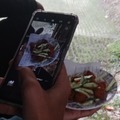 Taking a picture of food from a person taking a picture of food