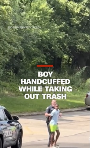 A 12-year-old-boy handcuffed while he was taking out the trash. Police say he matched the description of a suspected car thief in the area. - meme