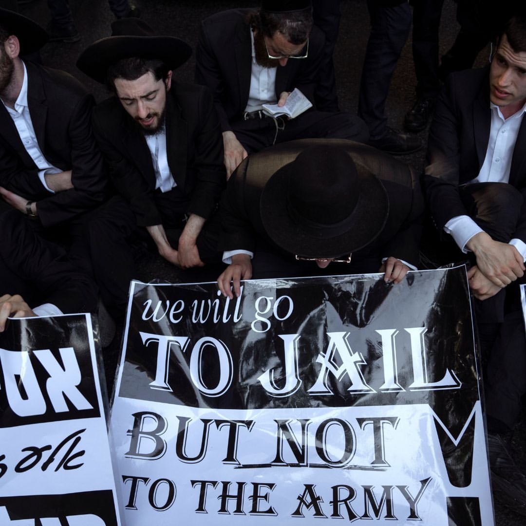 Hundreds of ultra-Orthodox Jewish men blocked a major highway in central Israel for two hours on Thursday to protest a recent Supreme Court decision ordering young religious men to enlist for military service. - meme
