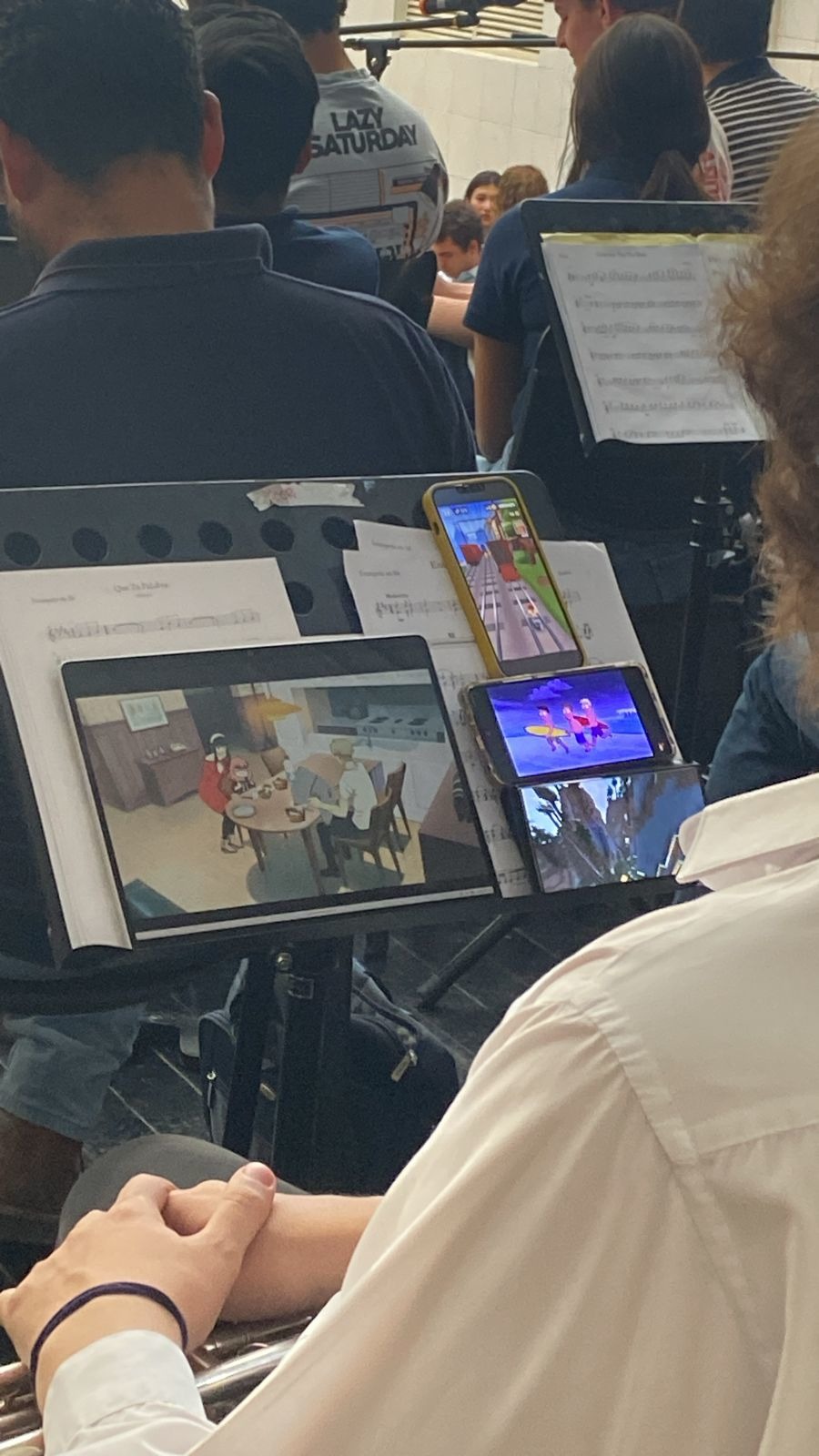 And that's what the trumpet section is doing while we play a mother's day mass (the one with the trumpet is our director btw he was just like bored or sum(I too am from trumpet section the picture was taken by the percussion guys)) - meme